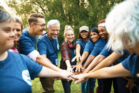 group of people with hands in the middle