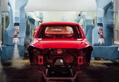 car being painted by an assembly machine