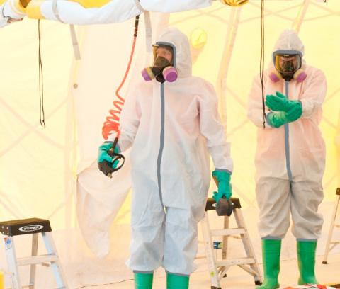 two people in hazmat suits